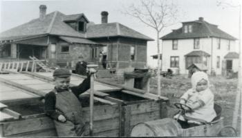 Red Deer Archives, P1754; Three children behind some houses, 19-?