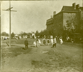 Black and white photo of children playing outside of St. Joseph's Convent in North Red Deer