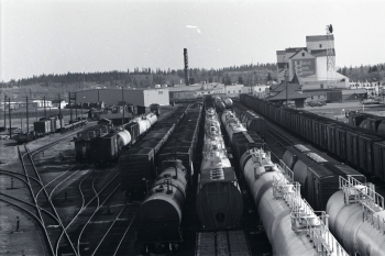 Black and white photo of train cars on the tracks at the Canadian Pacific Railway (CPR) railyards in Red Dee