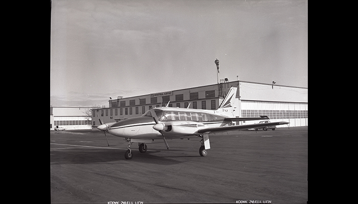 N4370, airplane in front of the main hanger building at the Red Deer Industrial Airport, 1971