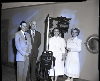 Black and white photo of the Red Deer Lions Club donating a mobile X-ray unit to the Red Deer Municipal Hospital in Red Deer