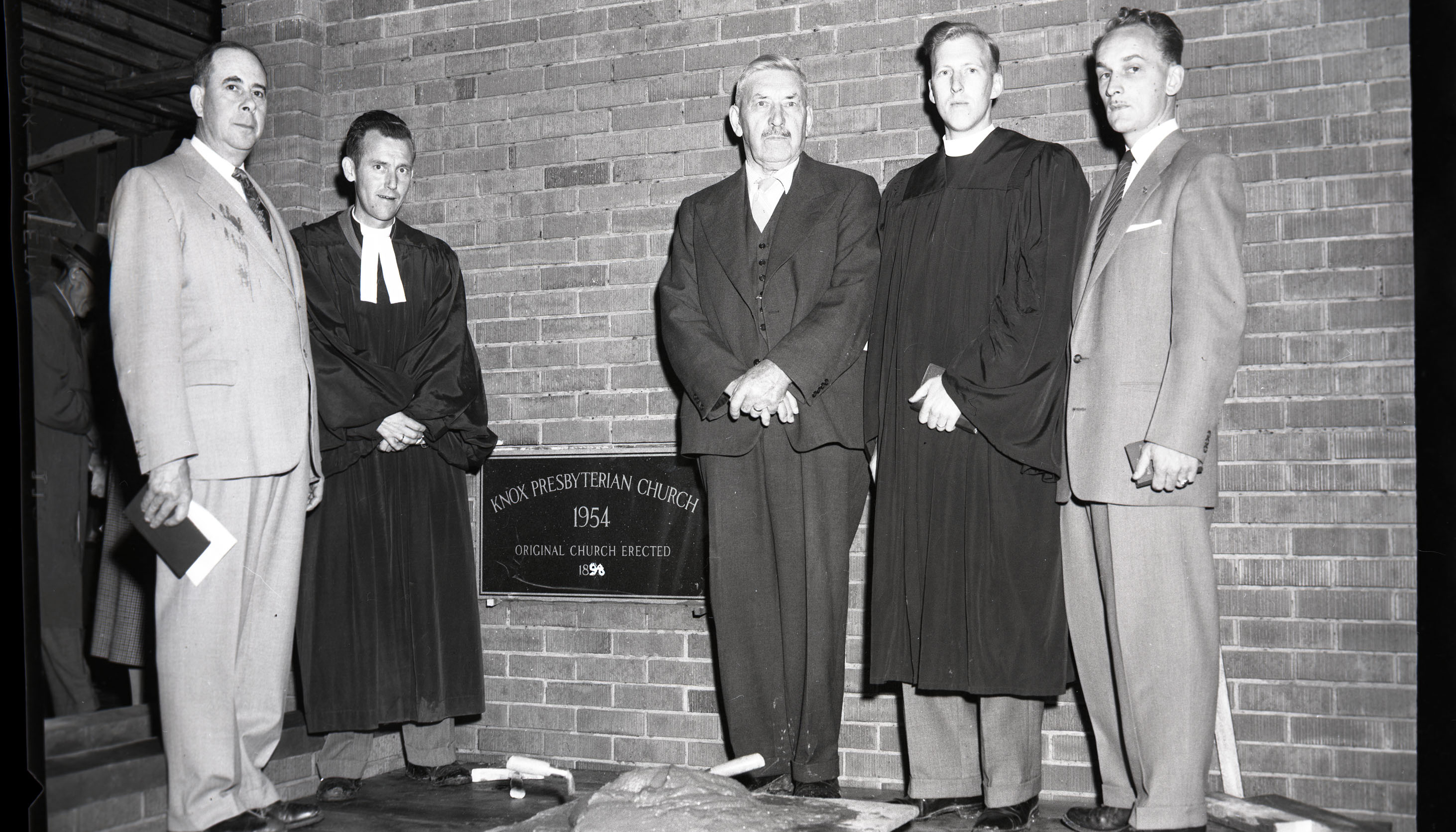 Black and white photo of five dignitaries at the corner stone ceremony at the new Knox Presbyterian Church on Ross Street