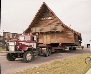 Coloured photo of the moving of the Chalet to its new location on the Westerner Exhibition grounds