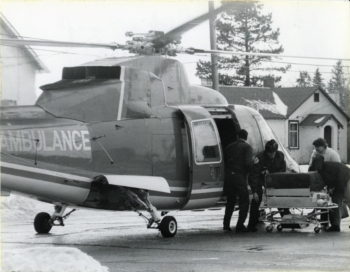 Black and white photo of an air ambulance bringing in equipment to the Red Deer Regional Hospital Centre