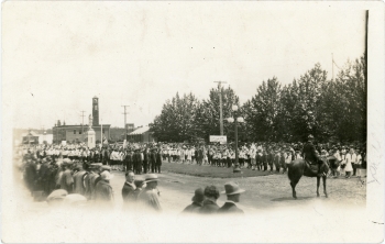 Black and white photo of the parade and crowd at the Canada's 60th anniversary celebrations on Ross Street