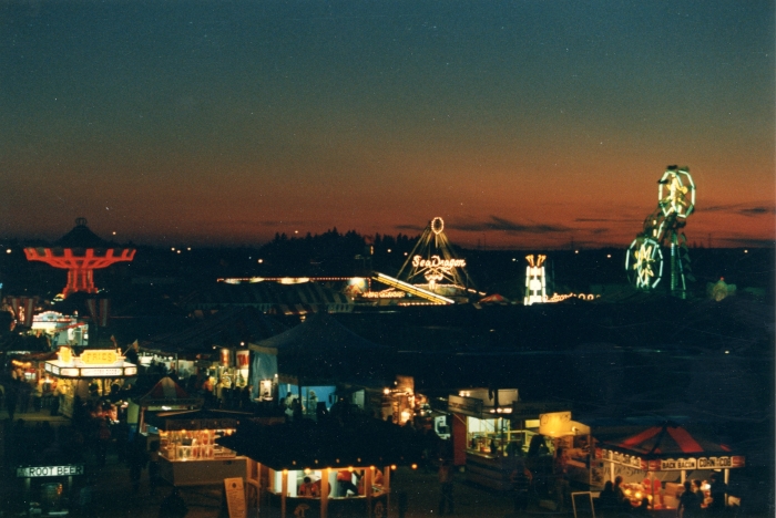 Colour photo of an exhibition midway in late evening, Red Deer, 1985