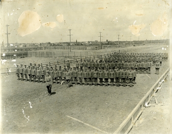 Black and white photo of members of the 89th Battalion drilling on the Red Deer Fair Grounds during the First World War