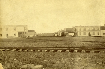 Black and white sepia toned photo of the view to east along Ross Street in 1891