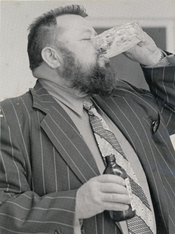 Black and white photo of Ben Ginter of Uncle Ben's Breweries taste testing a beer.