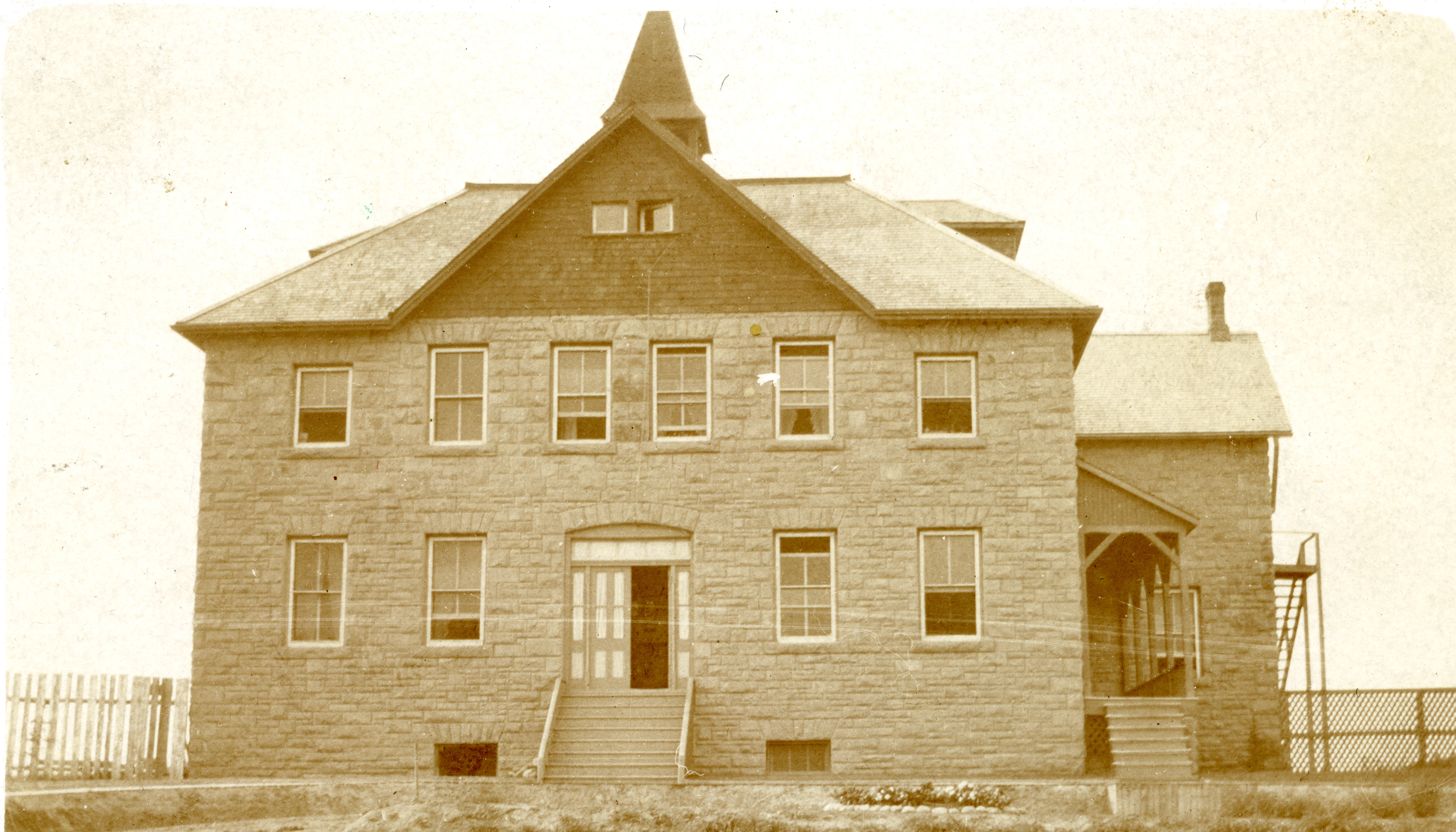 Black and white photo of the front of the Indian Industrial School near Red Deer that is operated by the Missionary Society of the Methodist Church