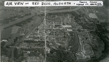 Black and white aerial photo of Red Deer from 1948 with text on a white background at the top 
