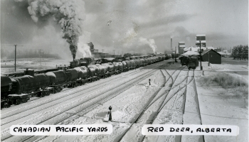 Black and white photo of a train with oil tanker cars at Red Deer, Alberta in 1947. Text at the bottom says 