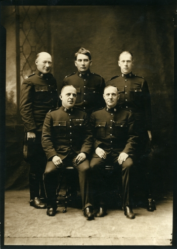 Black and white photo of five Alberta Provincial Police Officers dressed in full uniform