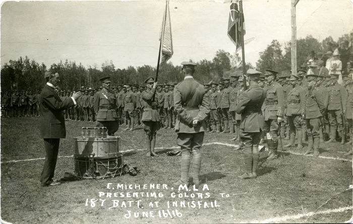 Black and white photo of Edward Michener presenting the colours to the 187th Battalion in Innisfail