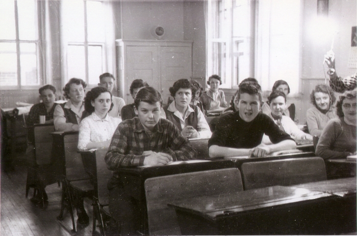 Black and white photo of high school students seated at desks in a classroom in 1955 in Red Deer, Alberta.