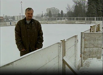 Screenshot of news clip featuring a man in an outdoor ice rink in Red Deer