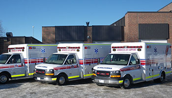 Three ambulances lines up outside fire station