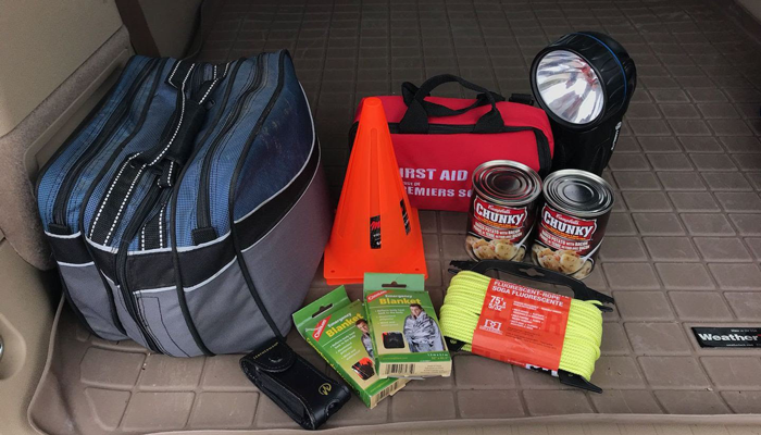 Photo of trunk of car with emergency items in it