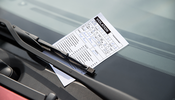 Parking ticket placed on vehicle windshield