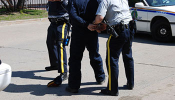 Male being arrested by two officers